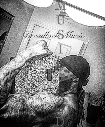 A man with tattoos on his arms and head.