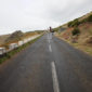 A person standing on the side of a road.