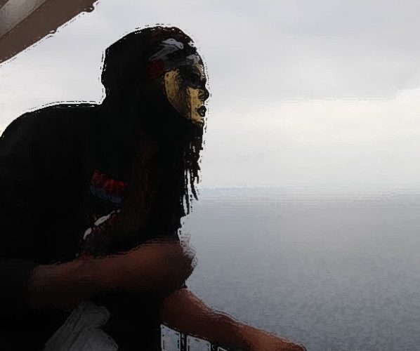 A man with long hair and a mask on.