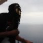 A man with long hair and a mask on.