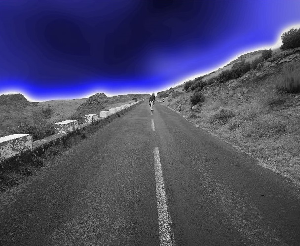 A person riding a bike on the side of a road.