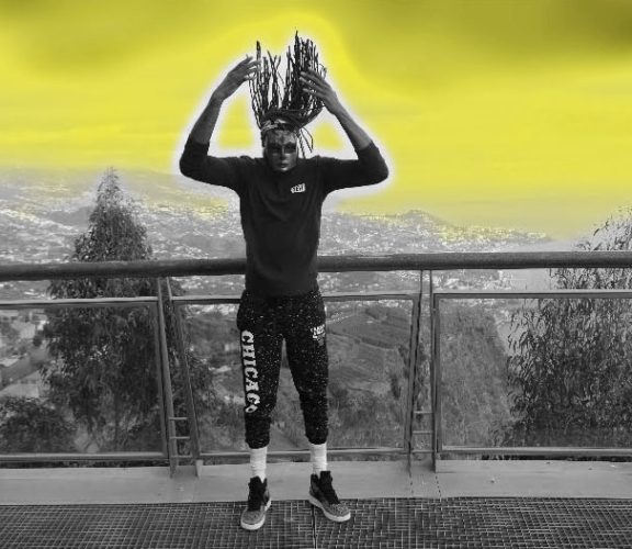 A man standing on top of a building with his hands in the air.