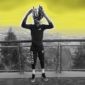 A man standing on top of a building with his hands in the air.