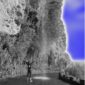 A person standing in front of a waterfall.