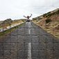 A person standing on the side of a road.