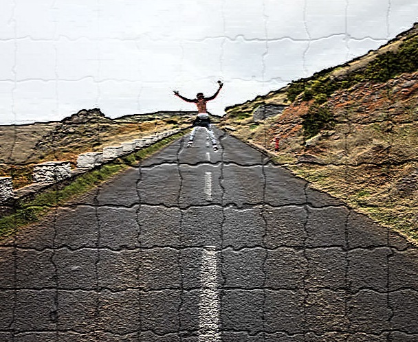 A person standing on the side of a road.