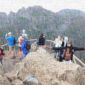 A group of people standing on top of a mountain.