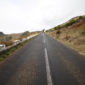 A road with a long stretch of asphalt on the side.