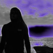 A person standing in front of the ocean.