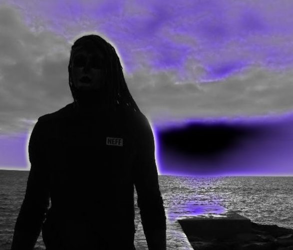 A person standing in front of the ocean.