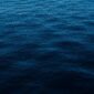 A dark blue sea with waves in the water.